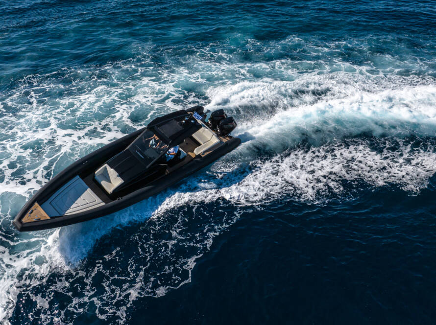 Aerial view of a high-performance black motorboat navigating open waters